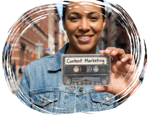 Smiling marketer holding a cassette tape labeled content marketing in an urban street setting